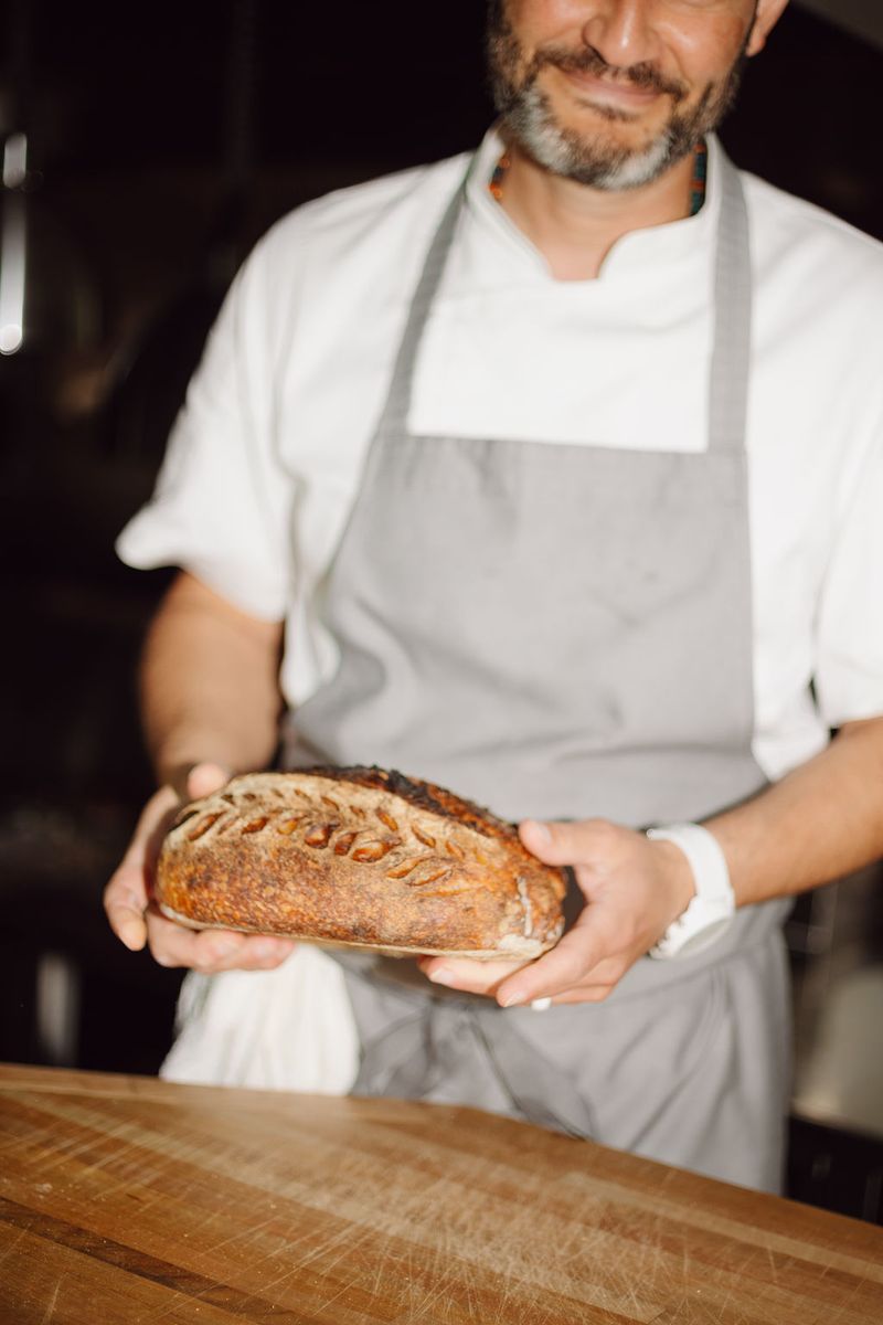 Chef holding a freshly baked loaf of bread
