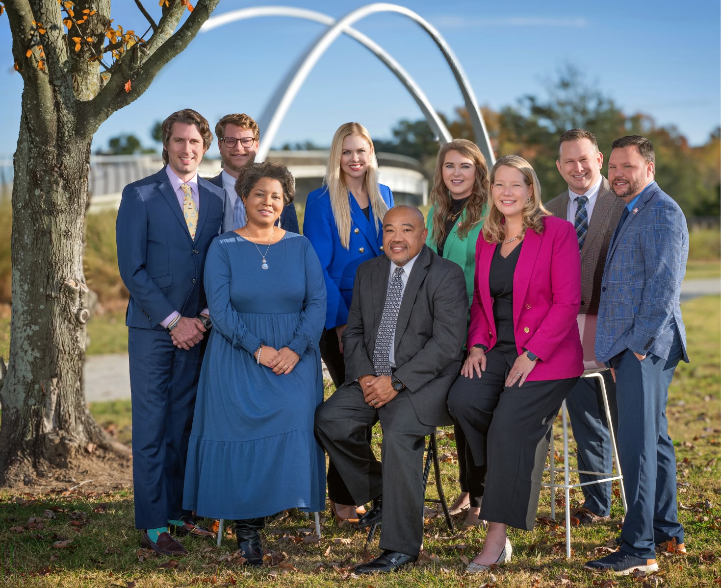 Group of CCED employees smiling and posing for a photo in front of a bridge