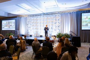Military keynote speaker addresses attendees from the stage during a Charleston County Economic Development luncheon event